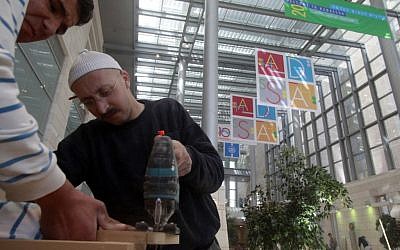 Workers putting the finishing touches on the new hospitalization center at Hadassah Ein Kerem (photo credit: Uri Lenz/Flash90)