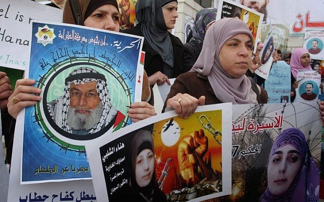 Palestinian women hold posters of Hana Shalabi (photo credit: Issam Rimawi/Flash90)