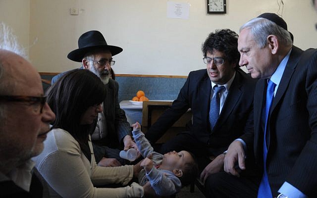 Prime Minister Benjamin Netanyahu visits Eva Sandler, wife of Rabbi Jonathan Sandler and mother of  Arieh and Gabriel, the victims of Monday's shooting in Toulouse. (photo credit: Amos Ben Gershom/GPO/FLASH90)