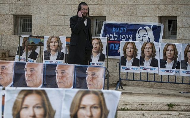 An ultra-Orthodox man walks among Kadima party election posters in Jerusalem, March 27, 2012 (photo credit: Yonatan Sindel/Flash90) An ultra-Orthodox man walks among Kadima party election posters in Jerusalem, March 27, 2012 (photo credit: Yonatan Sindel/Flash90)