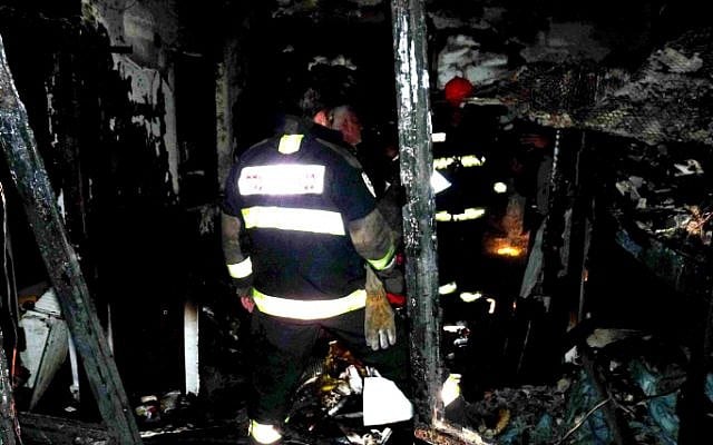 A firefighter examines the debris left over from the Rehovot house fire on Tuesday (photo credit: Yossi Zeliger/Flash90) A firefighter examines the debris left over from the Rehovot house fire on Tuesday (photo credit: Yossi Zeliger/Flash90)
