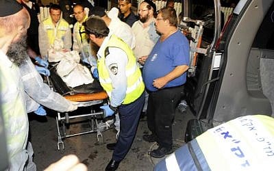 Rescue services personnel remove the bodies of the victims (photo credit: Yossi Zeliger/Flash90)