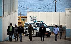 Ahmed Jamal Daif (2nd L), escorted by Israeli officers, arrives at the border crossing between Israel and Lebanon, in March 2012 (photo credit: Avishag Shaar Yashuv/Flash90)