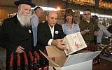 Shaul Mofaz gets to work by helping needy families for Passover (photo credit: Gideon Markowicz / Flash90)