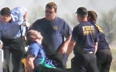 Emergency workers in Amarillo, Texas tend to a JetBlue captain who had a "medical situation" during a Las Vegas-bound flight, March 27, 2012. (photo credit: AP Photo/Steve Douglas)