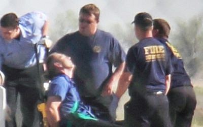 Emergency workers in Amarillo, Texas tend to a JetBlue captain who had a "medical situation" during a Las Vegas-bound flight, March 27, 2012. (photo credit: AP Photo/Steve Douglas)
