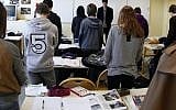 French students in a moment of silence the day after gunman Mohamed Merah murdered three children and a teacher at the Ozar Hatorah school in Toulouse, March 2012 (photo credit: Michel Spingler/AP)