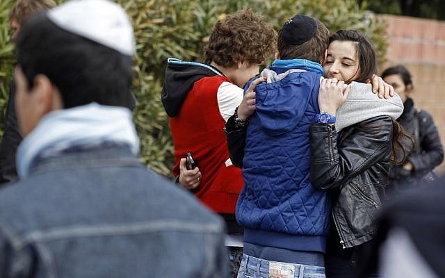 Students comfort each other at the Ozar Hatorah Jewish school where a gunman opened fire killing four people in Toulouse, on March 19, 2012. (AP/Remy de la Mauviniere) Students comfort each other at the Ozar Hatorah Jewish school where a gunman opened fire killing four people in Toulouse, on March 19, 2012. (AP/Remy de la Mauviniere)