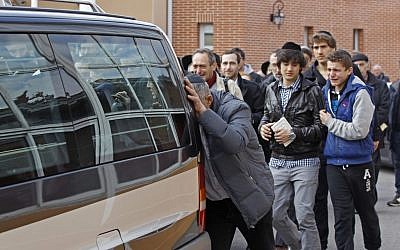 Mourners follow a hearse carrying the bodies of the victims outside the Ozar Hatorah school in Toulouse France Tuesday, (Photo credit: AP/Remy de la Mauviniere)