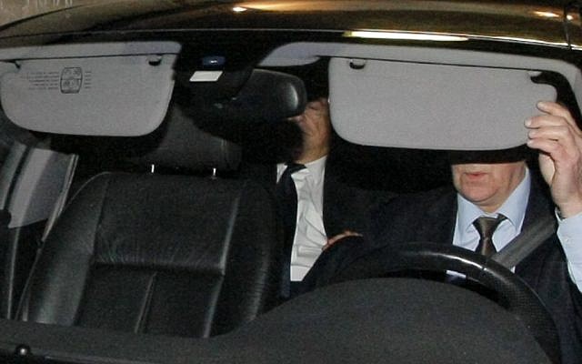 Strauss-Kahn, partially visible at center, leaves a court after being questioned in a probe into a suspected prostitution ring in Lille in March. (photo credit: AP/Michel Spingler)