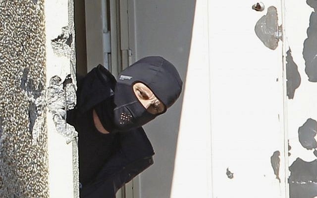 A masked police officer searches for clues at Mohamed Merah's apartment building in Toulouse in March. (Remy de la Mauviniere/AP) A masked police officer searches for clues at Mohamed Merah's apartment building in Toulouse in March. (Remy de la Mauviniere/AP)