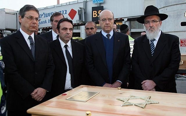 Deputy FM Danny Ayalon and French FM Alain Juppe stand behind one of the coffins at Ben-Gurion Airport (photo credit: Gideon Marcovitch/Foreign Ministry) Deputy FM Danny Ayalon and French FM Alain Juppe stand behind one of the coffins at Ben-Gurion Airport (photo credit: Gideon Marcovitch/Foreign Ministry)