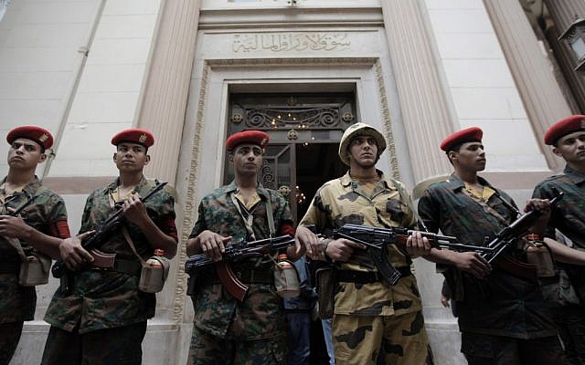 Egyptian army soldiers guard the entrance of Egypt's stock exchange in Cairo. Egypt's budget is undisclosed to the public. (photo credit: AP/Nasser Nasser, File)