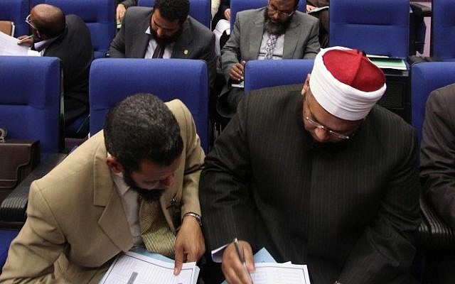 Egyptian lawmakers vote during a session to select a constitutional panel in Cairo (photo credit: AP/Ahmed Gomaa)