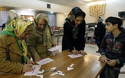 Iranian Jewish women fill in their ballots during the parliamentary elections, in Iran, March 3, 2012, (photo credit: AP Photo/Vahid Salemi)