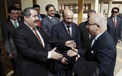 Iraqi foreign minister Hoshyar Zebari greets his Algerian counterpart in Baghdad (photo credit: AP/Mohammed Ameen)