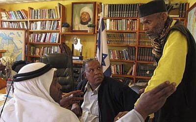Sheik Ayed al-Abed and Mohammed al-Masri and Khazrail Ben-Yehuda talk in a meeting room in the southern Israeli city of Dimona. (photo credit: AP)
