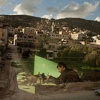 Palestinian calligraphy expert Adel Fauzy practices at his studio in the West Bank town of Hawara, near Nablus. (photo credit: AP/Bernat Armangue)