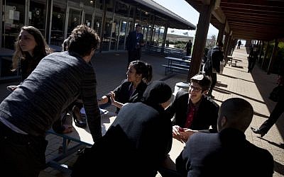 Students sit together during model United Nations 'peace negotiations' at the American International school in Even Yehuda. (photo credit: AP/Oded Balilty)