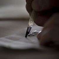 Calligraphy expert Avraham Borshevsky practices at his studio in Jerusalem. (photo credit: AP/Bernat Armangue)