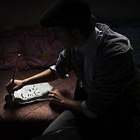 Palestinian calligraphy expert Qassem Sartawe, 22, prepares ink to be used for calligraphy works in the West Bank town of Bedya, near Nablus. (photo credit: AP/Bernat Armangue)