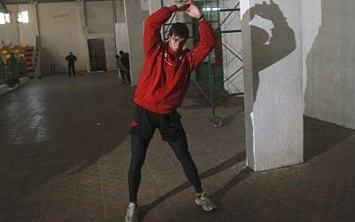 Palestinian athlete Bahaa al-Farra, who will compete the 400-meter Olympic race, trains at a gym in Gaza City. (photo credit: AP/Adel Hana)