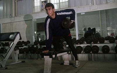 Bahaa al-Farra, who will compete the 400-meter Olympic race trains at a gym in Gaza City. (photo credit: AP/Adel Hana)