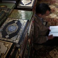 A Palestinian muslim worshipper reads the Holy book of Quran inside a Mosque in the West Bank city of Ramallah. (photo credit: AP/Bernat Armangue)