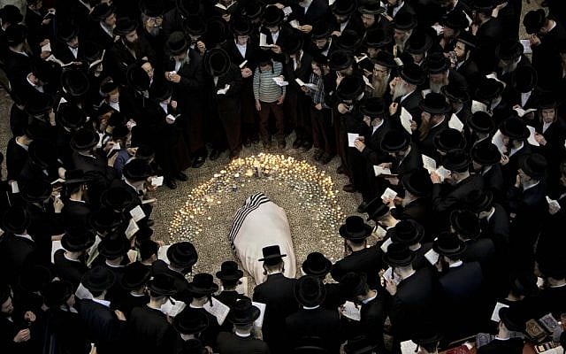 Ultra-Orthodox mourners surround the body of Rabbi Moshe Yehoshua Hager at his funeral in Bnei Brak on Wednesday. (photo credit: AP/Oded Balilty) Ultra-Orthodox mourners surround the body of Rabbi Moshe Yehoshua Hager at his funeral in Bnei Brak on Wednesday. (photo credit: AP/Oded Balilty)