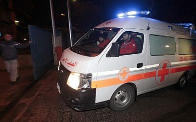 A Lebanese Red Cross ambulance follows Lebanese police vehicles carrying two injured French journalists who were trapped at Baba Amr neighborhood in Homs province. (photo credit: AP)