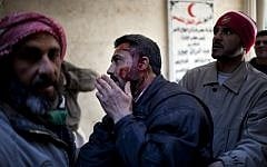 An injured man arrives at hospital in Syria (photo credit: AP Photo/Rodrigo Abd)