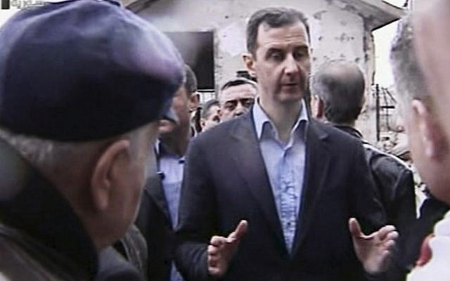 Syrian President Bashar Assad visits the Baba Amr neighborhood in Homs, Syria, on Tuesday. (photo credit: AP/Syrian State Television)