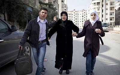 A family escapes from fierce fighting between opposition fighters and government troops in Idlib, north Syria, Saturday, March 10, 2012. (photo credit: AP Photo/Rodrigo Abd)