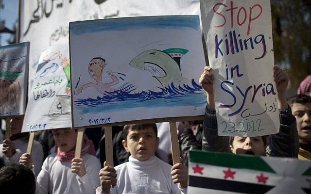 Children hold anti government posters during a protest in a town in north Syria. (photo credit: AP) Children hold anti government posters during a protest in a town in north Syria. (photo credit: AP)