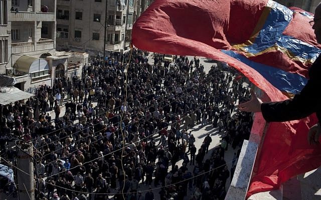 People attend an anti government protest in a town in north Syria. (photo credit: AP/Rodrigo Abd)