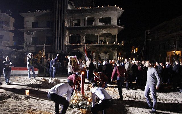 Syrian scouts place a candle during a vigil after a mass prayer for the civilian citizens and security officers who were killed in Damascus, Syria, on Wednesday (photo credit: Muzaffar Salman/AP )