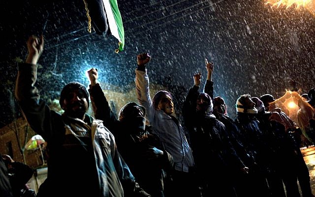 Free Syrian Army supporters chant anti government slogans under snowfall on the outskirts of Idlib , north Syria, on Wednesday (photo credit: AP Photo/Rodrigo Abd)