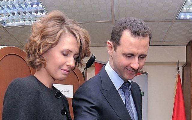 Bashar and Asma Assad at a polling station during a referendum on the new constitution (photo credit: AP Photo/SANA)