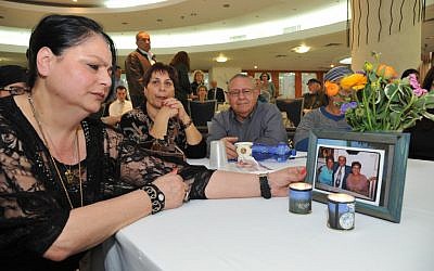 Dalia Falistian lights memorial candles for her parents at the Park Hotel 10 years after the Seder night massacre (photo credit: courtesy One Family)