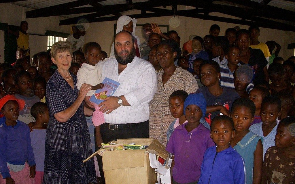 Ruth Feigenbaum, Traveling Rabbi Moshe Silberhaft and Patricia Tshabalala in the library for Aids orphans in Bulawayo (Photo credit: JTA) Ruth Feigenbaum, Traveling Rabbi Moshe Silberhaft and Patricia Tshabalala in the library for Aids orphans in Bulawayo (Photo credit: JTA)
