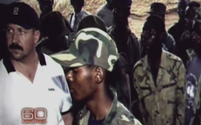 Viktor Bout, aka the Merchant of Death (left), in West Africa in his early career (photo credit: screen capture, "60 Minutes," YouTube) Viktor Bout, aka the Merchant of Death (left), in West Africa in his early career (photo credit: screen capture, "60 Minutes," YouTube)