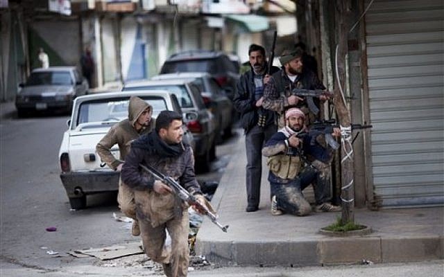 Syrian rebels take position during clashes with government forces in Idlib, north Syria. (photo credit: AP) Syrian rebels take position during clashes with government forces in Idlib, north Syria. (photo credit: AP)