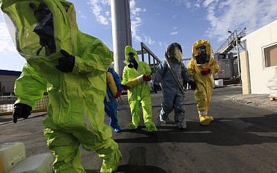 Bad chemistry: Israeli firemen participate in a missile attack drill. (photo credit: Tsafrir Abayov/Flash90)
