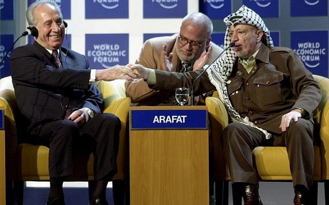 Yasser Arafat shakes hands with Shimon Peres at the World Economic Forum in Davos, 2001 (photo credit: CC BY-SA World Economic Forum) Yasser Arafat shakes hands with Shimon Peres at the World Economic Forum in Davos, 2001 (photo credit: CC BY-SA World Economic Forum)