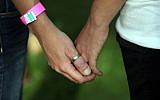 Female participants hold hands during a gay pride parade in Jerusalem (photo credit: Yossi Zamir/Flash90/File)