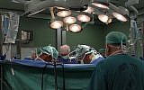 Illustrative: Doctors perform surgery at a hospital in Israel (Nati Shohat/Flash90)