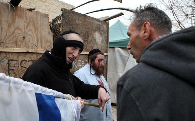 Jewish settlers and pro-Palestinian activists clash during a protest at the entrance to the Sheikh Jarrah neighborhood of Jerusalem. (photo credit: Sliman Khader/Flash90)