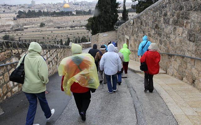 Tourists walk down Mount of Olives towards the Old City of Jerusalem in February 2012. (photo credit: Nati Shohat/Flash90)