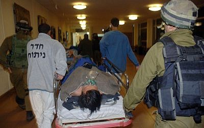 Thai workers, injured when rockets fired from Gaza into southern Israel hit the area of Eshkol, are brought into the Soroka hospital late Friday night. (photo credit: Dudu Greenspan/Flash90)
