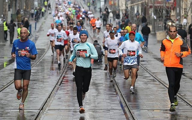 Runners slogging down Jaffa Street in the Jerusalem Marathon (photo credit: Nati Shohat / Flash90)